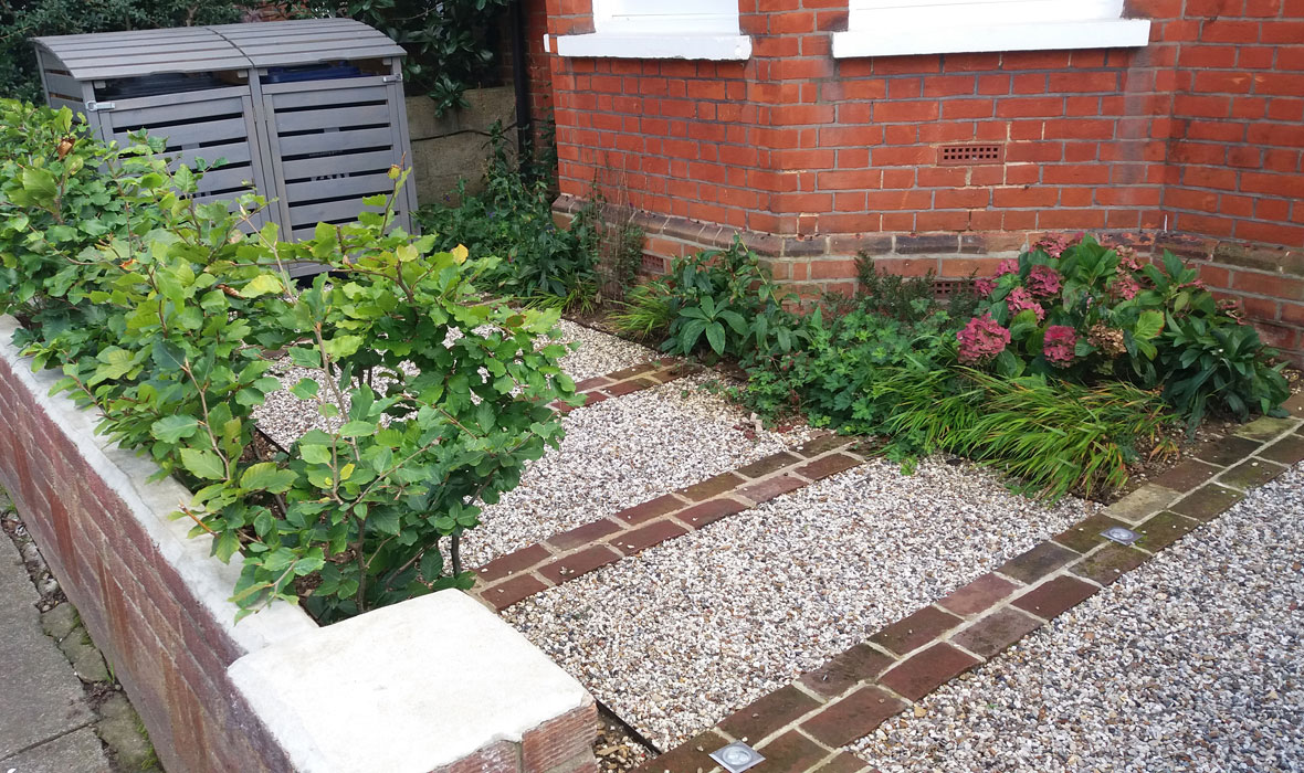 Bands of clay pavers and flint gravel set in a honeycomb matrix